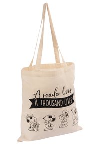 Borsa in cotone color crema con illustrazioni nere di cani cartoni animati e la scritta "Un lettore vive mille vite" sul davanti.