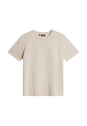 Beige Baumwoll-T-Shirt mit kurzen Ärmeln, Rundhalsausschnitt und einem kleinen Logo oben links. Schmeichelnde Textur und lockere Passform.