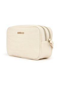 Rectangular beige cosmetic bag with embossed wavy pattern, dual zippered compartments, small side handle, and gold DERIMOD logo on front.
