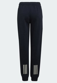 Navy sweatpants made of soft fabric, featuring an elastic waistband, tapered legs, and three reflective stripes at the lower sides.