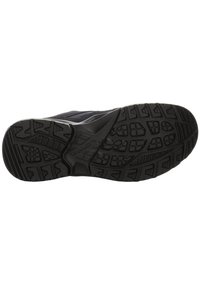 Black athletic shoe sole with rugged tread pattern, featuring textured rubber for traction and reinforced edges for durability.