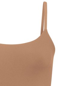 Light brown bra featuring a smooth texture, minimalistic design, and thin adjustable straps, designed for comfort and a secure fit.