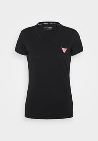 Svart v-ringad t-shirt i ekologisk bomull. Har korta ärmar och en liten röd triangulär logotyp på vänster bröst. Slät textur.