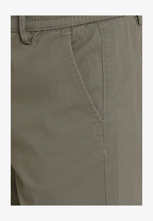 Khaki pants made from soft fabric, featuring a regular fit, side pockets, and subtle stitching details, showcasing a smooth texture.