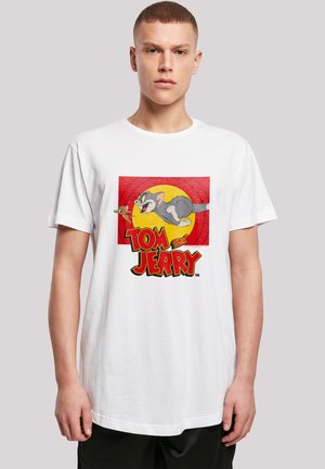 White cotton t-shirt featuring a colorful "Tom and Jerry" graphic, with a cartoon cat and mouse, set against a red and yellow background.