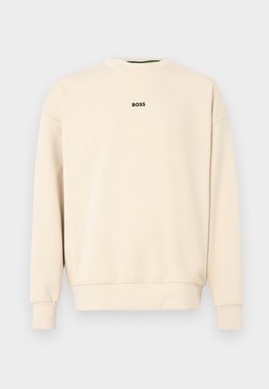 Bézs színű pulóver kerek nyakkal, hosszú ujjal és mandzsettával. Hátul egy kis fekete "BOSS" logó található. Sima textúra.