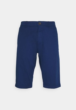 Shorts bleu marine en coton, avec fermeture à boutons, devant plat, ourlets retroussés et poches latérales. Texture lisse et design décontracté.
