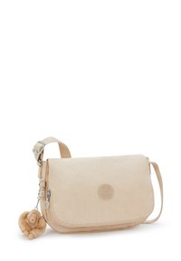 Borsa a tracolla beige in tessuto morbido, con chiusura a patta e tracolla regolabile. Presenta un logo circolare e un grazioso ciondolo a forma di scimmia attaccato.