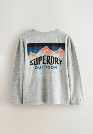 Grauer Sweatshirt mit langen Ärmeln und Rundhalsausschnitt. Auf der Rückseite ist eine bunte Gebirgsgrafik sowie der Text "SUPERDRY OUTDOOR" zu sehen. Sanfte Textur.