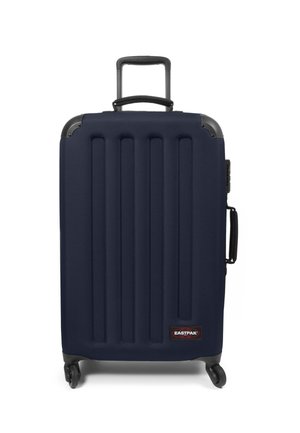 Navy hard-shell suitcase with vertical grooves, retractable handle, and wheels. Features EZ branding tag and textured surface for grip.