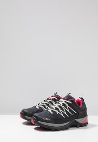 Black and pink hiking shoes with a textured upper, reinforced toe, and waterproof material. Features include white laces and a patterned sole.