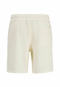 Krémové textúrované šortky so stretávaným elastickým pásom a jedným nášivkovým vreckom na pravej strane.