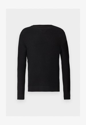 Juodas megztinis su tekstūriniais raštais, apvaliu iškirpimu, ir ribotais rankogaliais bei apatine dalimi. Medžiaga atrodo minkšta ir tankiai supinta.