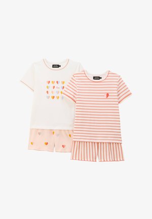 Ensemble de deux pyjamas : un haut blanc avec des motifs de cœurs colorés et un haut rayé rose avec un accent en forme de cœur ; shorts assortis avec des cœurs.