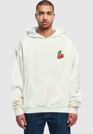 White hooded sweatshirt made of soft fabric features a small cherry graphic on the chest. Kangaroo pocket and ribbed cuffs.