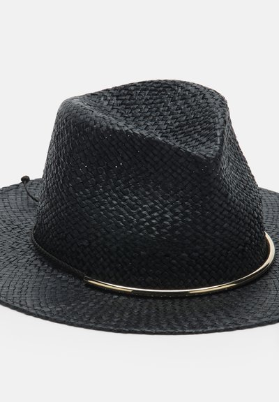 Chapeau fedora noir tissé avec large bord et une fine bande métallique autour de la base de la calotte sur fond blanc.