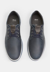 Navy leather shoes with a smooth surface, featuring white rubber soles, round laces, and a textured accent on the tongue. Inside labeled "Bata."