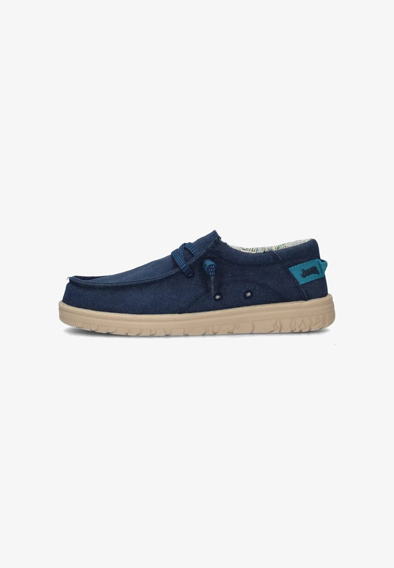 Scarpa slip-on in tela navy con suola in gomma beige, dettagli blu, cuciture decorative e fodera interna a fantasia.