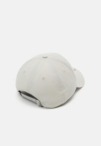 Lys grå caps med en lett strukturert design. Har en buet skygge, justerbar bakrem og seks ventilasjonsluker.