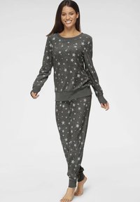 Gray pajama set featuring a long-sleeve top and pants adorned with white stars. Soft material and elastic cuffs with a simple, casual design.