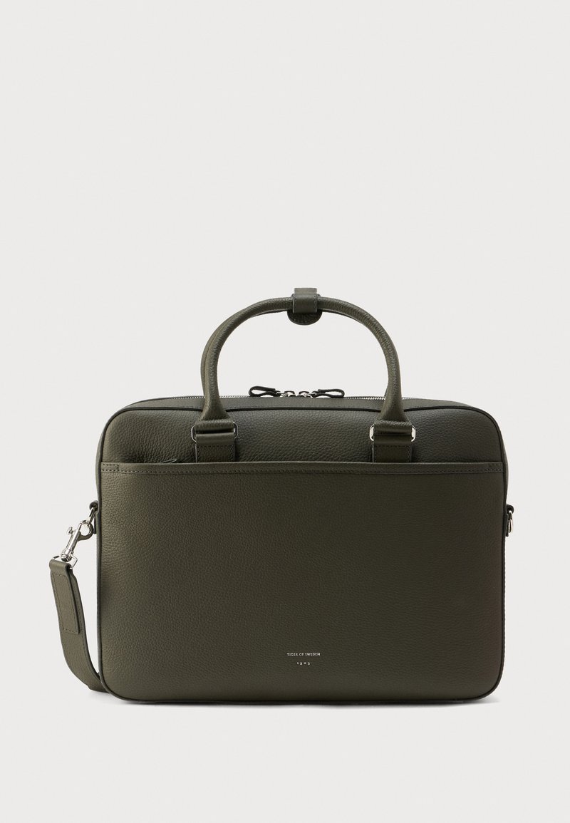 Πράσινη δερμάτινη τσάντα για laptop με διπλές λαβές, ρυθμιζόμενο ιμάντα ώμου και ασημένιο φερμουάρ κλεισίματος. Λείο υφή με διακριτική λεπτομέρεια επωνυμίας.
