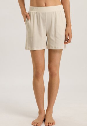 Pantaloni beige realizzati in tessuto morbido, con una cintura elastica, tasche laterali e una vestibilità ampia per il massimo comfort.