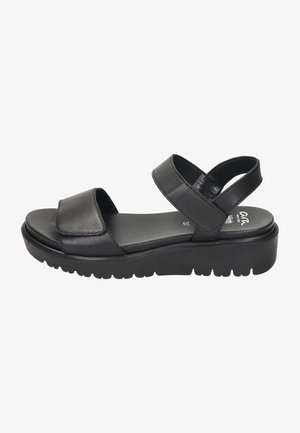Sort lædersandal med to brede stropper, en polstret sål og en tyk, struktureret ydersål for greb. Minimalistisk design og flad profil.