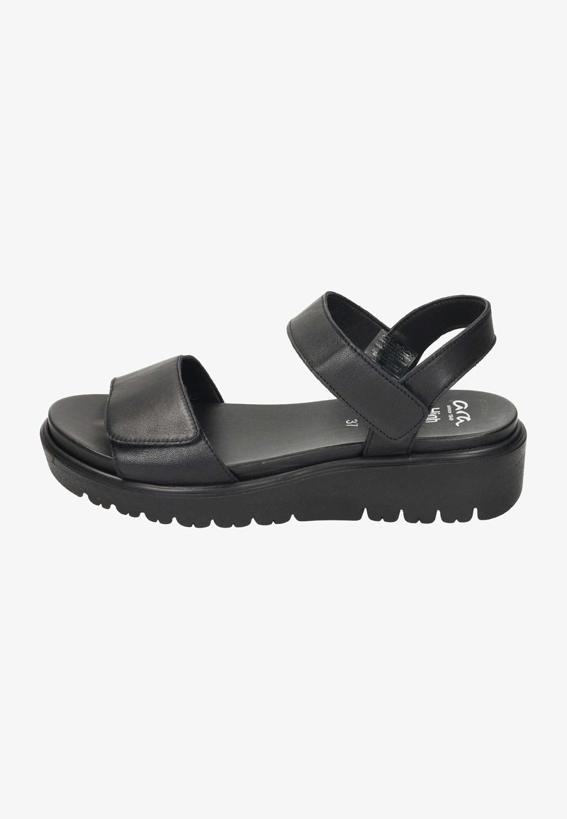 Sandal in pelle nera con due ampie cinghie, suola imbottita e suola esterna spessa e testurizzata per una buona presa. Design minimalista e profilo piatto.