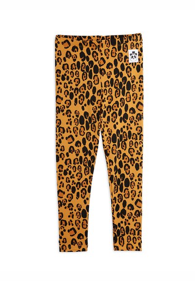 Leggings med leopardmönster i orange och svart, tillverkade av elastiskt tyg. Har en elastisk midja och en mjuk, slät textur.
