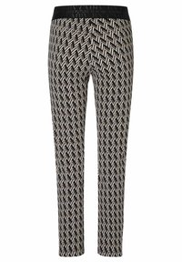 Pantalon à motifs noirs et blancs avec un design en zigzag, doté d'une ceinture élastique noire avec texte en relief. Coupe slim avec une texture lisse.