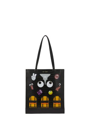 Black tote bag with textured surface, decorated with cartoon eyes, peace hand sign, smiley, and colorful patches reading "NO," "Yes!," and "@."