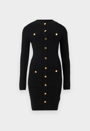 Black fitted knit dress with long sleeves, gold buttons down the front, and four gold-buttoned pockets, two on chest and two at hips.