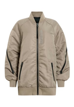 Beige bomber jacket with a quilted design, ribbed collar and cuffs, zippered pockets, and a patch panel on the front.