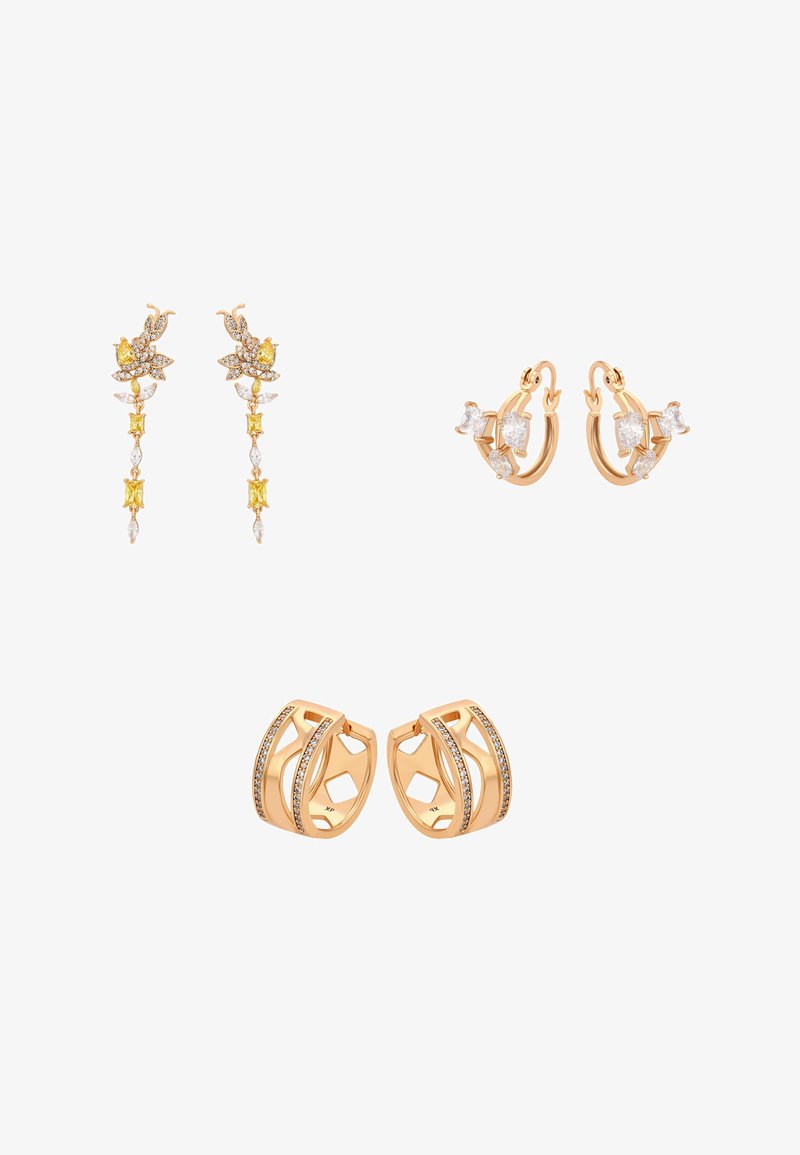 Kolme paria kultakoruja: pitkät riipukset, joissa keltaisia ja valkoisia kiviä, pienet renkaat, joissa kirkkaat jalokivet, ja leveät bandit upotetuilla kristalleilla.