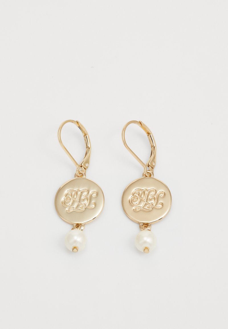 Zlato obarvane uhane s krožno diskasto obliko in gravirano zasnovo ter visečo belo biserno kroglico. Lahka kovinska konstrukcija.