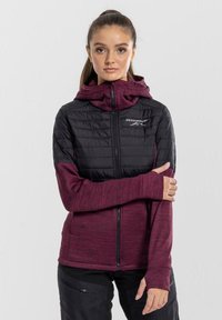 Black and maroon insulated jacket with a hood, featuring a zippered front and thumbholes, textured fabric, and a logo on the chest.