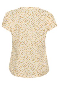 Blouse à manches courtes en tissu blanc avec un motif abstrait de points jaunes et oranges. Encolure arrondie et design d'ourlet courbé.