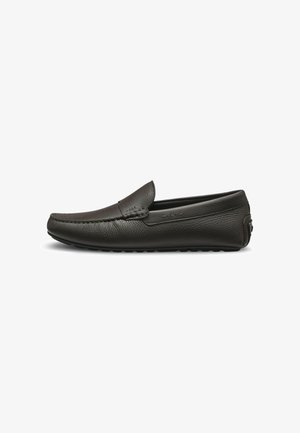 Mocasín negro de cuero sin cordones con detalles cosidos y suela de goma, mostrado de lado sobre fondo blanco.