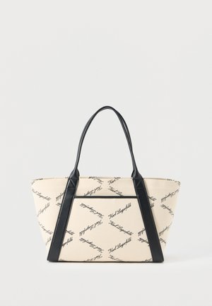 Smėlio spalvos rankinė su juodomis rankenomis ir akcentais, audinyje pavaizduotas juodas įstrižas „Karl Lagerfeld“ užrašas.