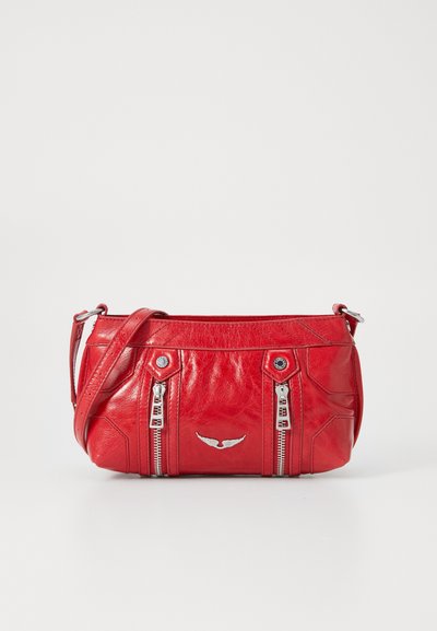 Red leather handbag with zippered compartments, silver hardware accents, and a subtle wing emblem on the front. Compact design with shoulder strap.