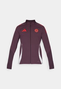 Bordo sportinė striukė su pilnu užtrauktuku, aukštu apykakle, raudonomis detalėmis ir šoninėmis panelėmis. Apima Adidas logotipą ir apvalų komandos emblemą ant krūtinės.