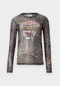 Pikad varrukad, läbipaistev must topp, millel on tiigri graafika rhinestone'idest ja loomakarva mustrite hulk. Omab ümmargust kaelust.