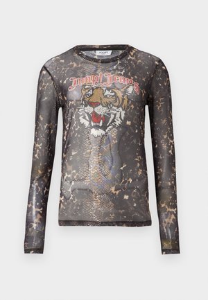 Top a maniche lunghe, trasparente, di colore nero con una grafica di una tigre realizzata in strass e un motivo che ricorda il pelo degli animali. Presenta un collo rotondo.