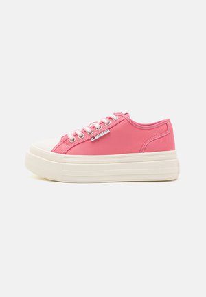 Pink canvas sneakers with a textured finish, white rubber toe cap, and thick white platform sole. Features metal eyelets and laces.