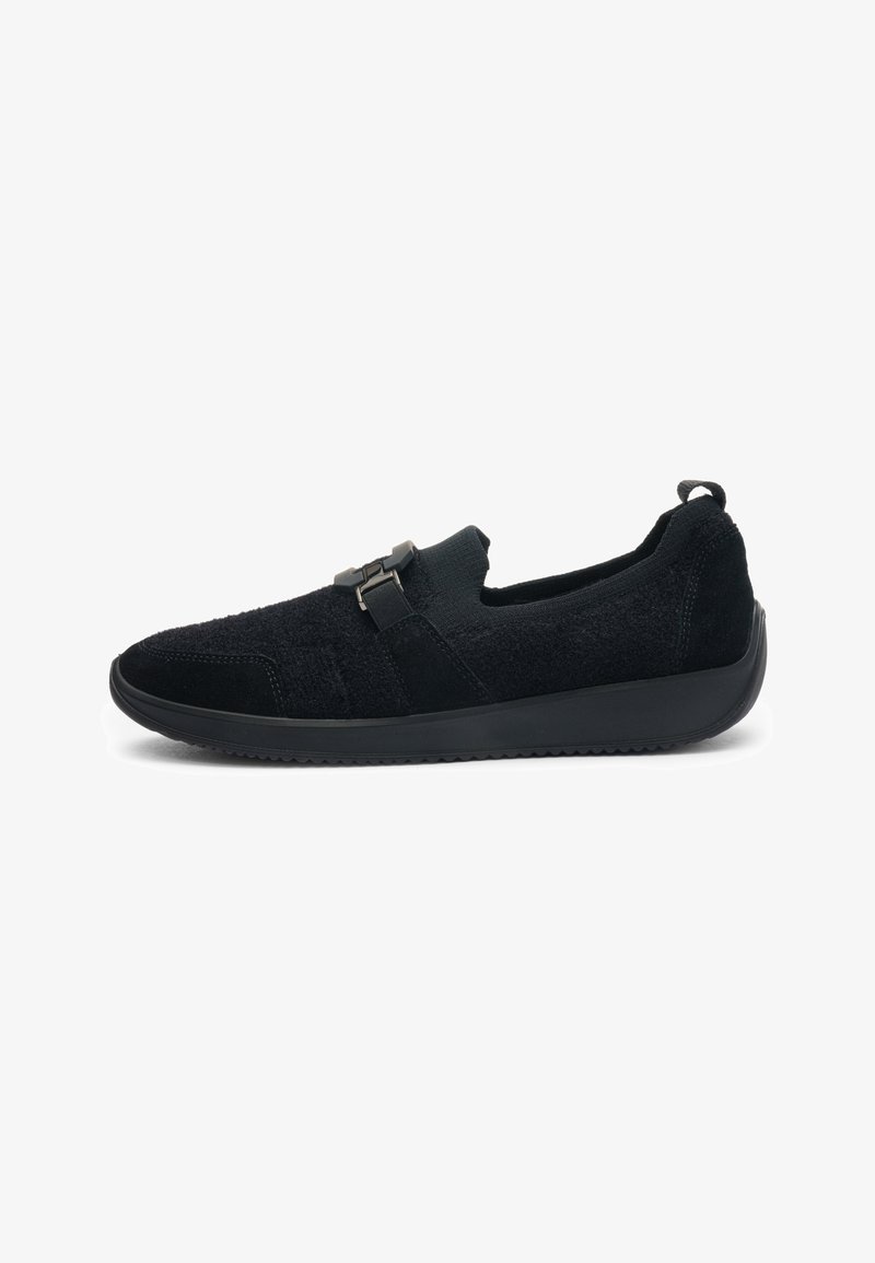 Black slip-on shoe with textured fabric upper, rubber sole, and front strap with buckle detail, shown in side profile.
