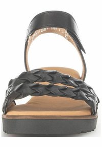 Sandal in pelle nera con cinturini intrecciati, suola piatta e soletta imbottita. Presenta un cinturino sopra il piede per una vestibilità sicura.
