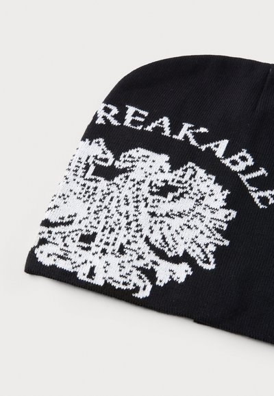 Berretto nero con testo bianco "UNBREAKABLE" e grafica di un'aquila. Il motivo a maglia è fine e dettagliato, con una texture liscia e una forma arrotondata.