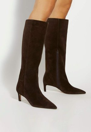 Brown suede knee-high boots with a pointed toe and a low heel. Features a side zipper for easy wear. Smooth texture throughout.