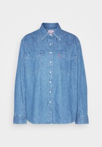 Lichtblauwe denim overhemd met een klassieke puntkraag, twee borstzakken en knoopsluiting. Beschikt over subtiele stiksel en lange mouwen.