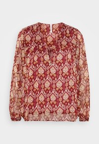 Camicia a maniche lunghe trasparente con motivo geometrico rosso, bianco e senape, scollo a V con dettaglio a fiocco e polsini elastici.